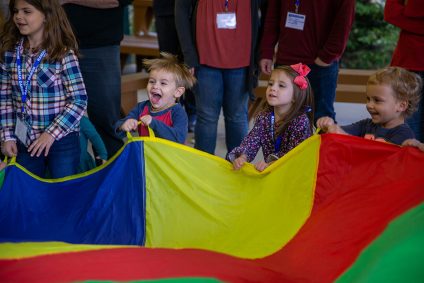 Photo of kids playing with a parachute