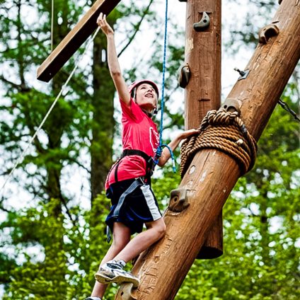 A boy climbing the tower at Ramah Darom, a Jewish summer camp.