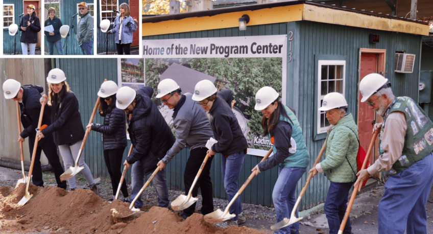 people in hard hats and shovels bending over dirt pile 