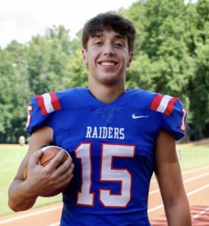 Levi in football uniform holding ball